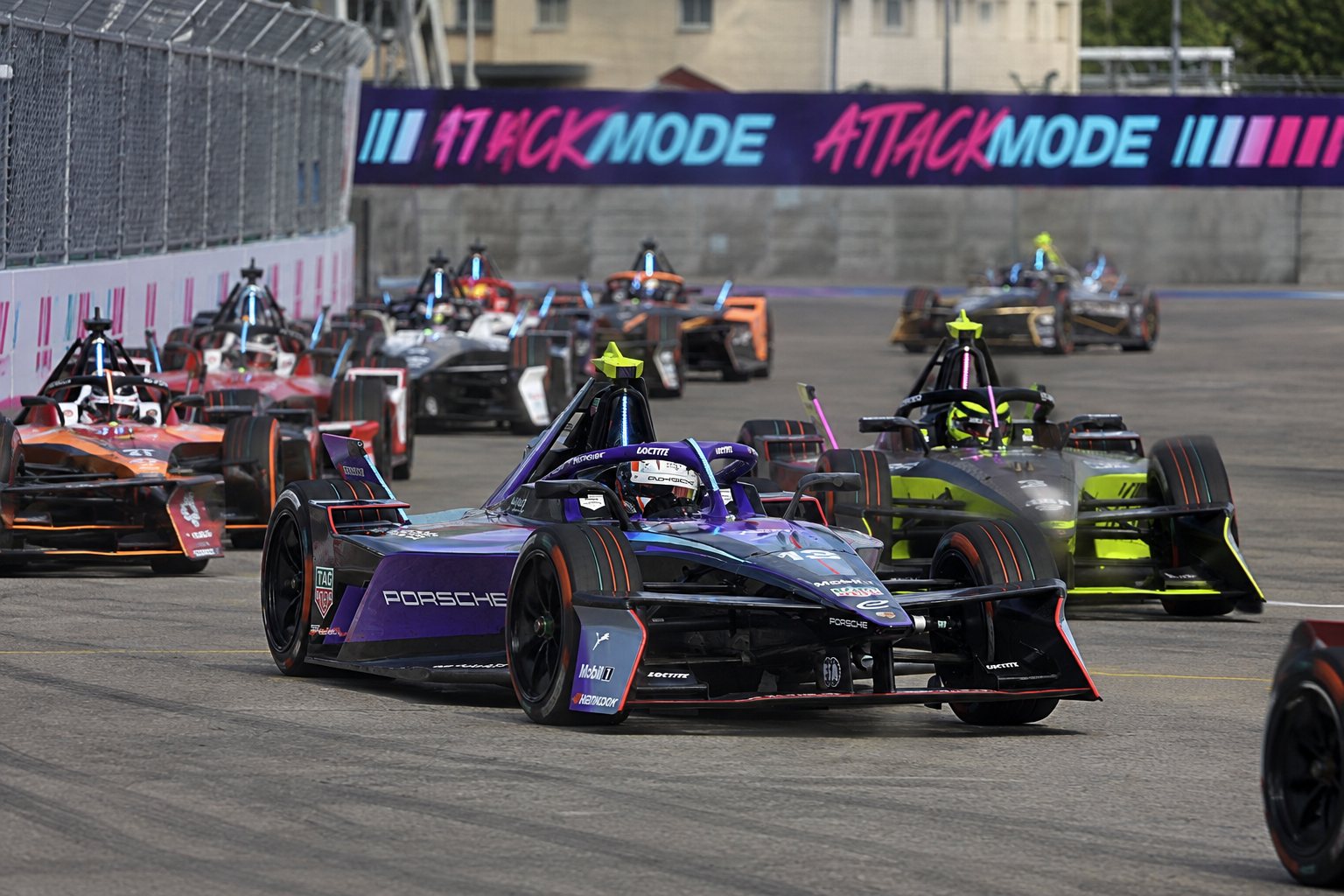 Formula E car on concrete at Tempelhofer Feld, Berlin with fan village and crowd